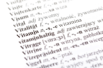 Word vitamin - witamina in a Polish - German dictionary line pointed out, selective focus, macro, closeup, detail Medicine supplementation, immunity foreign language medical translation simple concept