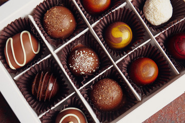 Box with delicious chocolate candies, closeup