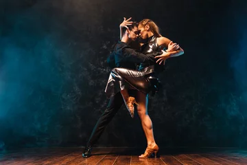 Fotobehang young couple in elegant evening dresses dancing © Maksim Toome