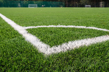 white markings on the stadium with artificial turf corner of the field