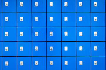 Full frame close-up of stack of bright blue boxes highlighted by silver locks