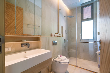 Interior design in bathroom of villa, house, home, condo and apartment feature basin, shower, mirror and towels