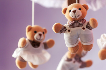 Baby music mobile carousel with little bears. Toy carousel, above the baby bed. Baby bedroom close...