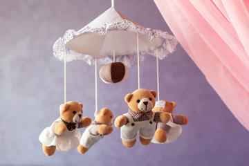Baby music mobile carousel with little bears. Toy carousel, above the baby bed. Baby bedroom close up element. © tygrys74