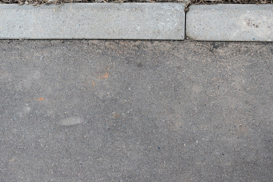 Grey texture of asphalt surface and paving bar. Background of asfalt and stones