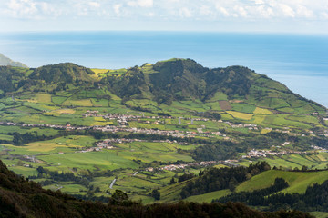 Obraz premium View on town of Furnas, located in the same name a civil parish in the municipality of Povoacao on the island of Sao Miguel in the Portuguese Azores, as seen from the Pico do Gaspar Belvedere.