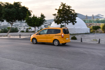 car taxi of type leisure activity vehicle (LAV) driving by street