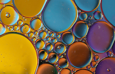 Oil drops on a water surface with brillant colors (Abstract background image)