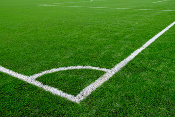Obraz premium white corner markings on a football field with artificial turf