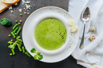 Delicious spinach puree decorated with quail egg. Top view. Healthy eating and diet concept.