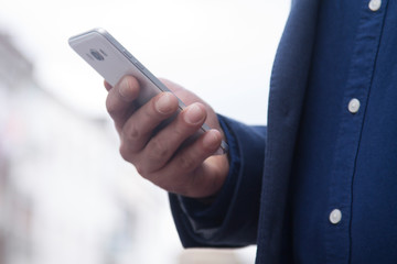 businessman using mobile or cell phone on the office balcony. close up view
