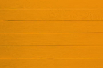Vintage orange wood background . Old wooden plank painted in orange color.