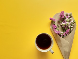 coffee and a bouquet of purple flower