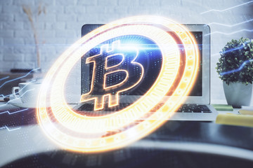 Multi exposure of blockchain and crypto economy theme hologram and table with computer background. Concept of bitcoin cryptocurrency.