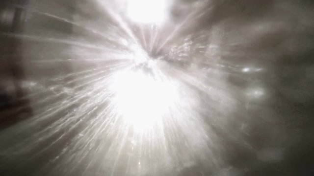 Under the shower jet, footage taken from below of a shower spraying water jets inside a bathroom bathtub. Wasting of water concept.