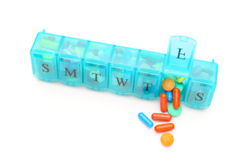 Container with pills on white background