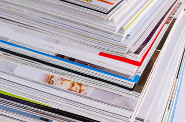 Closeup background of a pile of magazines.