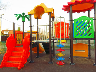 outdoor Playground made of bright plastic elements with slides and ladders