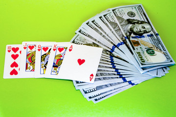 Poker combinations of cards on the background of dollar bills