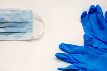 Virus protection surgical face mask and gloves for  coronavirus placed on white background with copy space