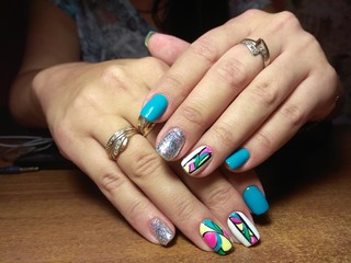 The manicurist excellently made her work a beautiful manicure with a polish gel on her hands and the client is happy
