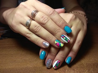 The manicurist excellently made her work a beautiful manicure with a polish gel on her hands and the client is happy
