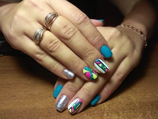 The manicurist excellently made her work a beautiful manicure with a polish gel on her hands and the client is happy
