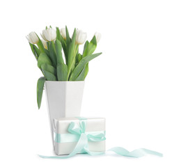 Gift box and beautiful flowers on white background