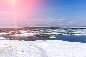 Spring landscape with melting snow on the lake. spring landscape