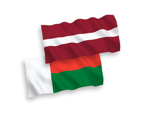 Flags of Latvia and Madagascar on a white background