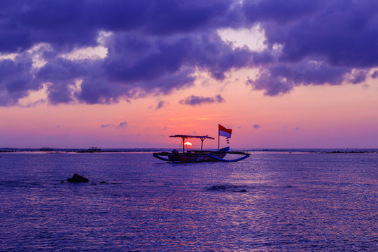 Typical Indonesian fishing boat at the sunset on Kuta Beach, Bali, Indonesia