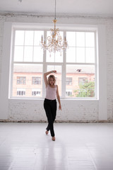 Portrait of young business woman white shirt black trousers pants isolated, Goes and dances, raises hands