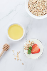 a cup of yogurt and strawberries on the table
