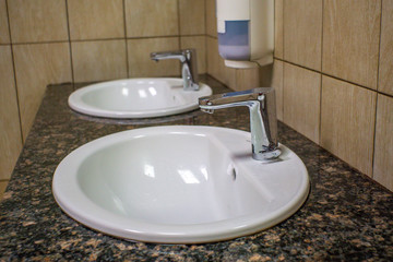 Fototapeta premium Toilet sink interior of a public toilet with hand washing