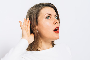 Overhears a woman, tries to listen.