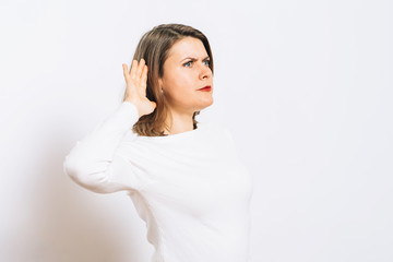 Overhears a woman, tries to listen.