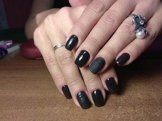 The manicurist excellently made her work a beautiful manicure with a polish gel on her hands and the client is happy
