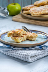 Fluffy homemade pancakes with apple dusted with icing sugar