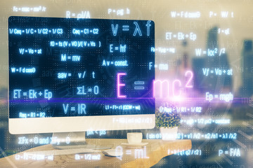 Desktop computer background and formula hologram writing. Double exposure. Education concept.