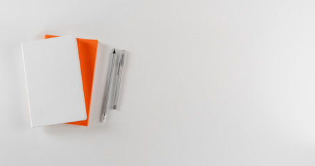 Blank notebooks with pen on white background. Top view, copy space.
