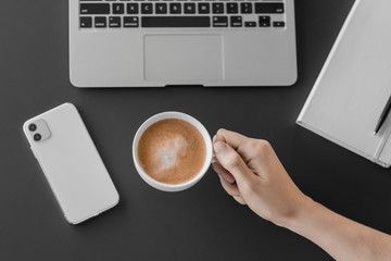 Businessman holding a cup in hand. Coffee break office. Flat lay, top view