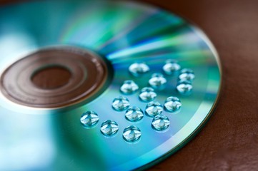 Drops of water on a compasc disc with blue filter in macro view