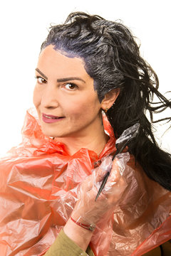 Happy woman applying black dye hair