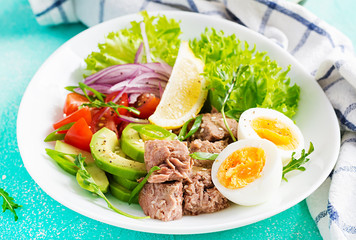 Healthy food. Tuna fish salad with eggs, lettuce, cherry tomatoes, avocado and red onions.  French cuisine.