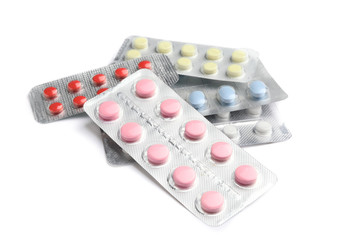 Different pills on white background