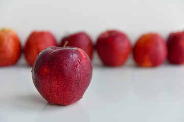 ripe red apples in water drops close up