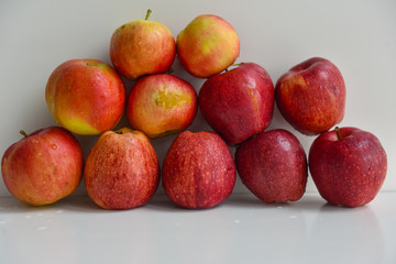 ripe red apples in water drops close up