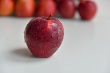 ripe red apples in water drops close up