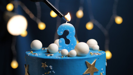 Birthday cake number 3 stars sky and moon concept, blue candle is fire by lighter. Copy space on...