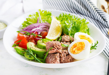 Healthy food. Tuna fish salad with eggs, lettuce, cherry tomatoes, avocado and red onions.  French cuisine.